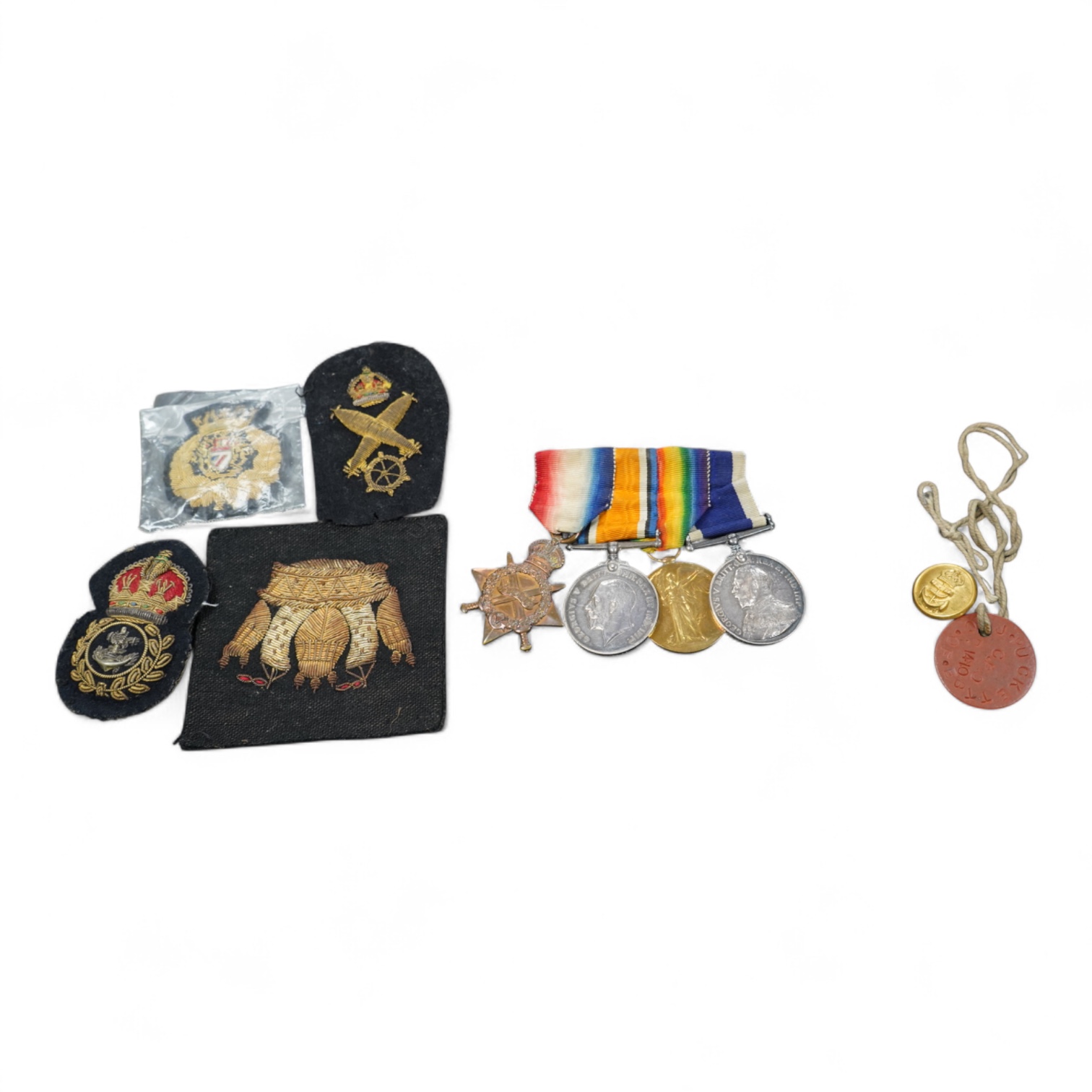 A WWI medal group including Good Conduct awarded to 226989 JHW.PUCKETT.PO.RN. (HMS PEMBROKE) together with cloth badges and a tag